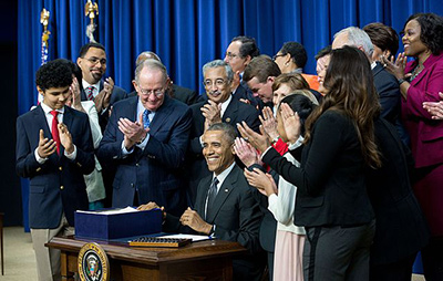 President Obama signing the Every Student Succeeds Act