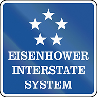 Road sign labeled “Eisenhower Interstate System”