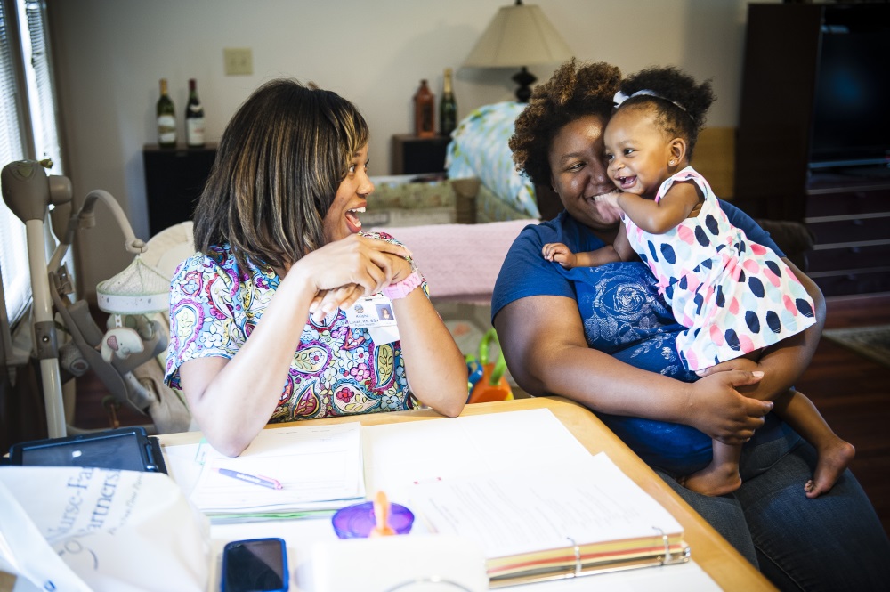 Mother with child and nurse